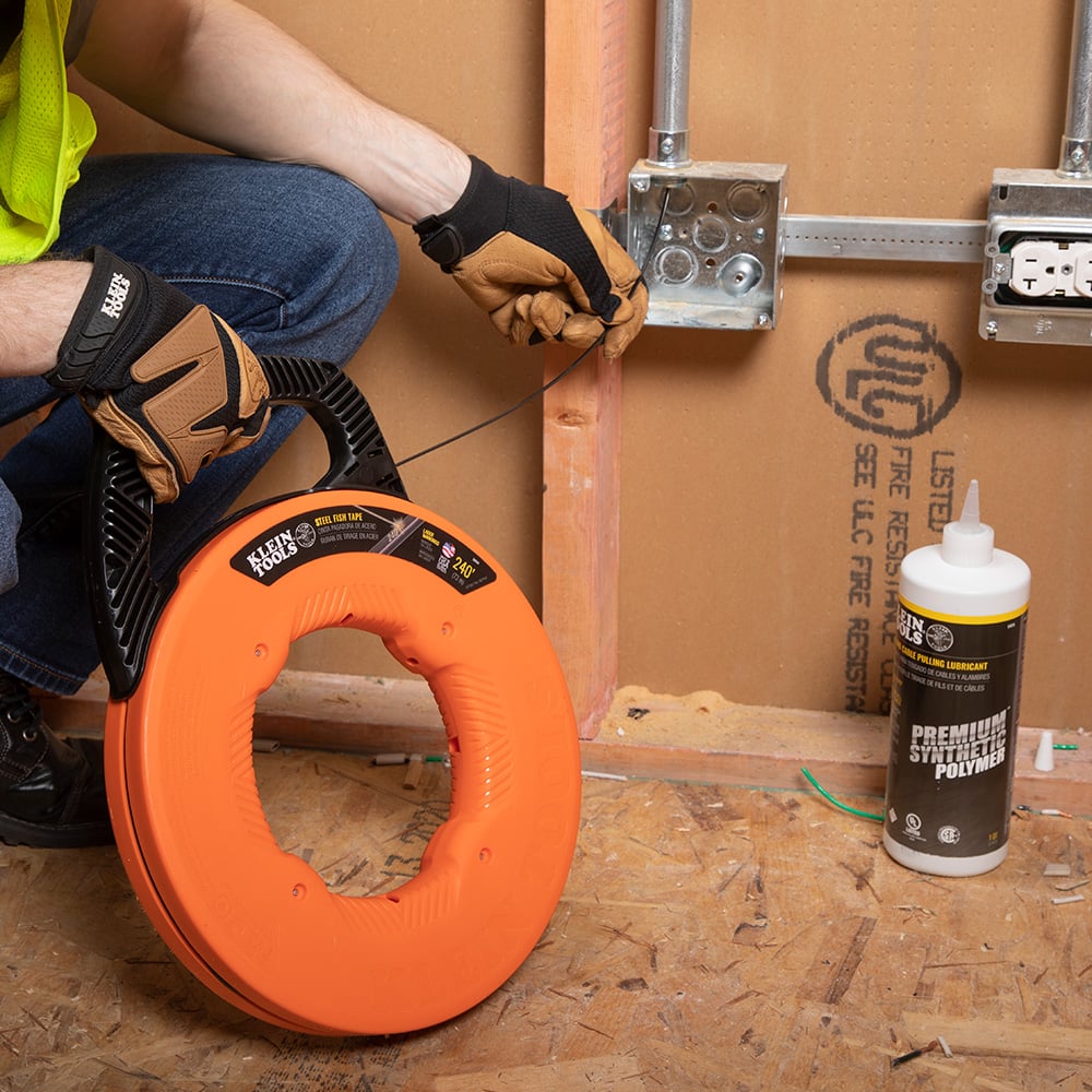 Alternate image of STEEL FISH TAPE, 1/8 IN X 240 FOOT in use.